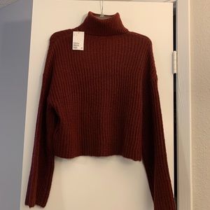 H&M sweater with loose turtleneck and bell sleeves. New with tags size S